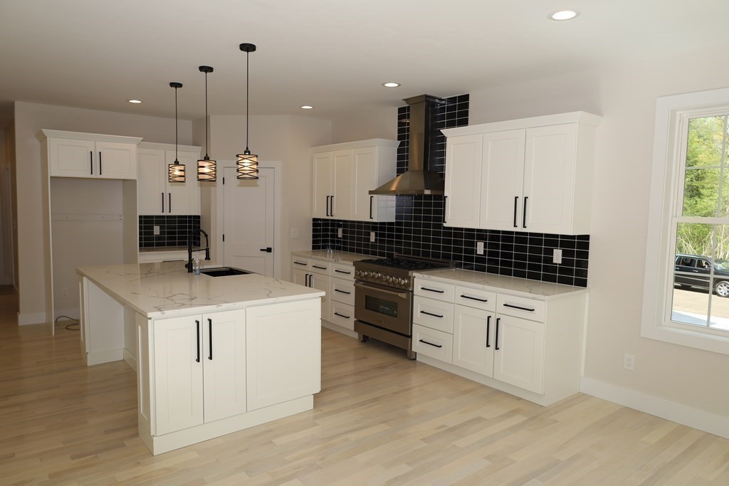 109 North Road Westfield, MA 01085 - Photo 15 of 41 a kitchen with a stove and white cabinets