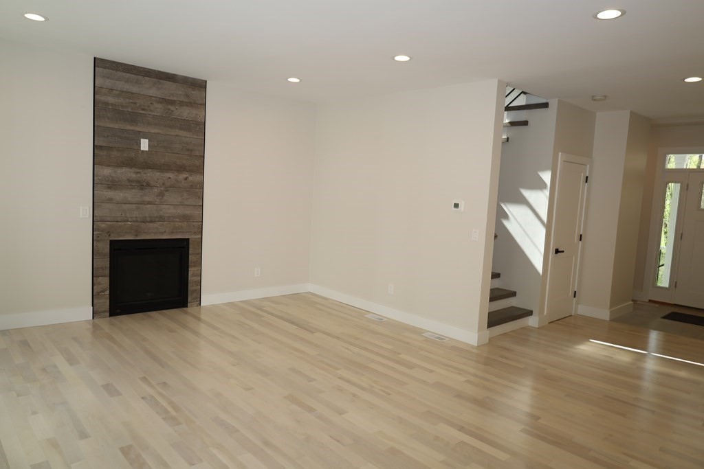 109 North Road Westfield, MA 01085 - Photo 25 of 41 an empty room with wooden floor and a fireplace