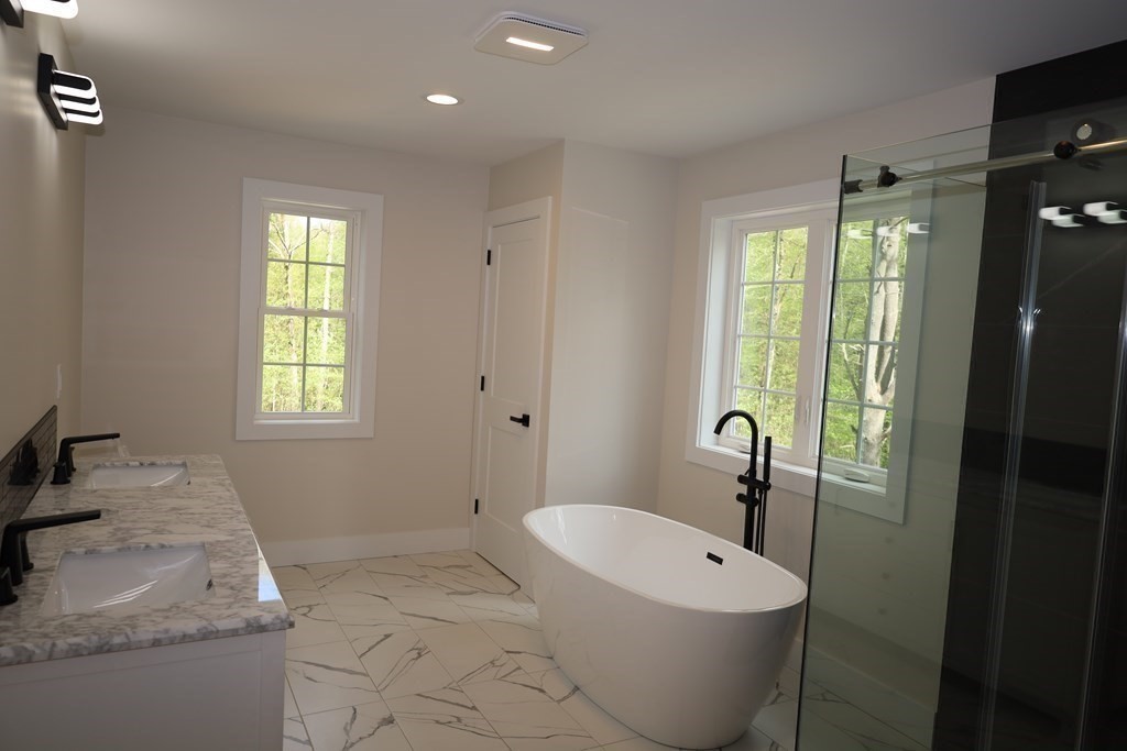 109 North Road Westfield, MA 01085 - Photo 35 of 41 a bathroom with a granite countertop sink a toilet a mirror and bathtub