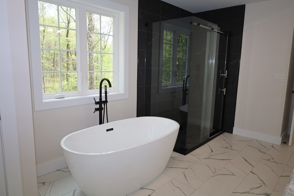 109 North Road Westfield, MA 01085 - Photo 38 of 41 a white bath tub sitting in a bathroom next to a window