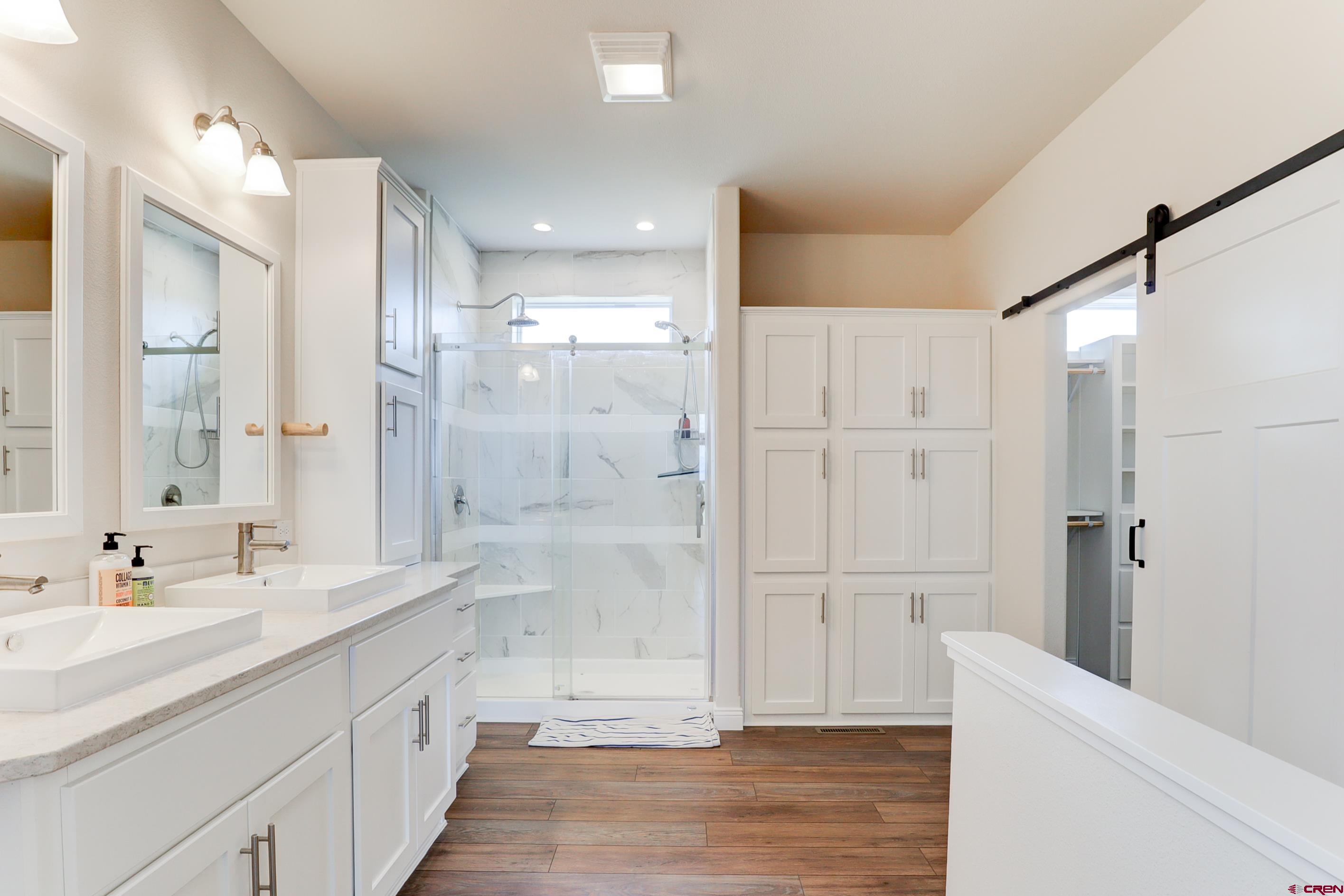 22667 Rd L Cortez, CO 81321 - Photo 13 of 35 a bathroom with a shower sink and a mirror