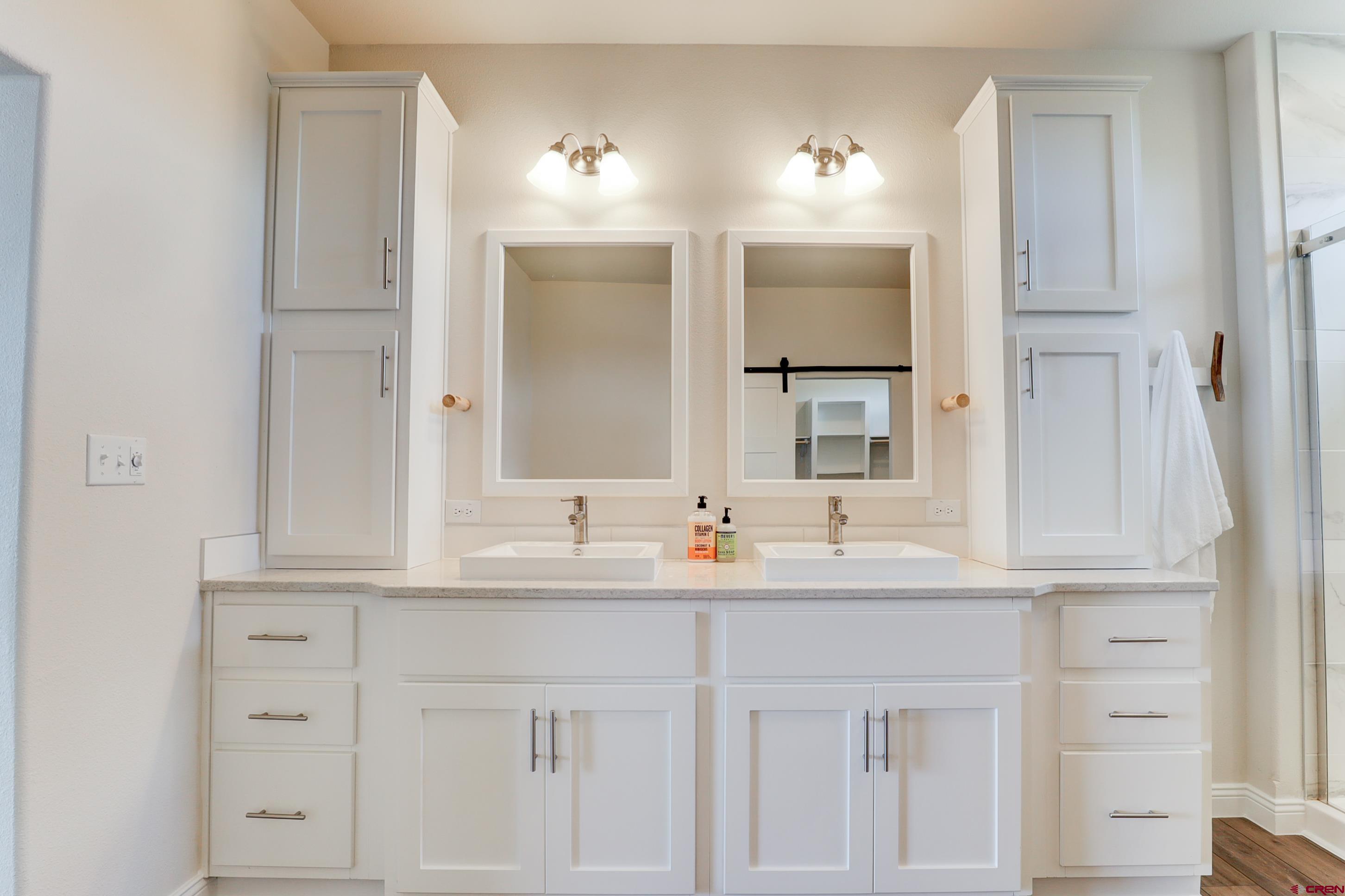 22667 Rd L Cortez, CO 81321 - Photo 14 of 35 a bathroom with double sink and a mirror