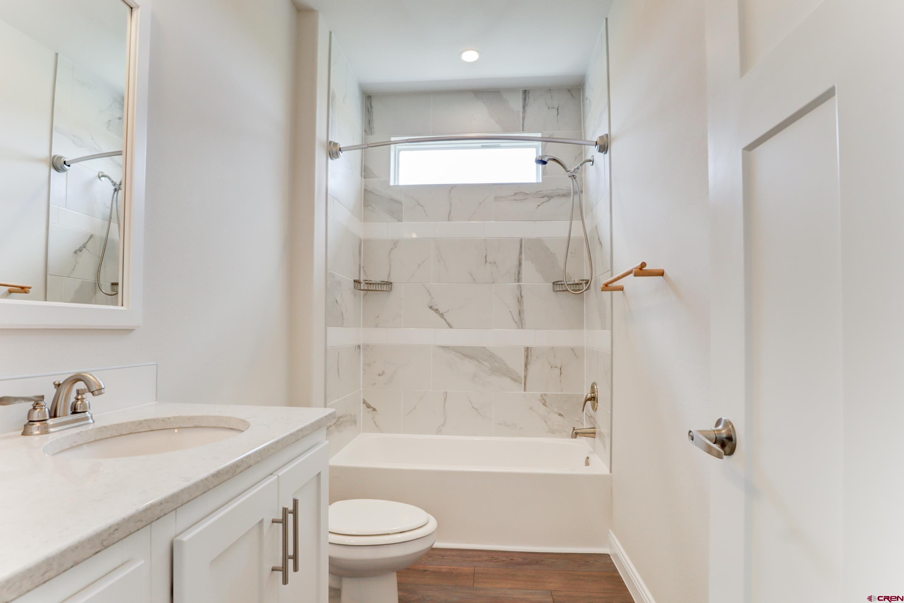 22667 Rd L Cortez, CO 81321 - Photo 20 of 35 a bathroom with a granite countertop sink toilet and shower