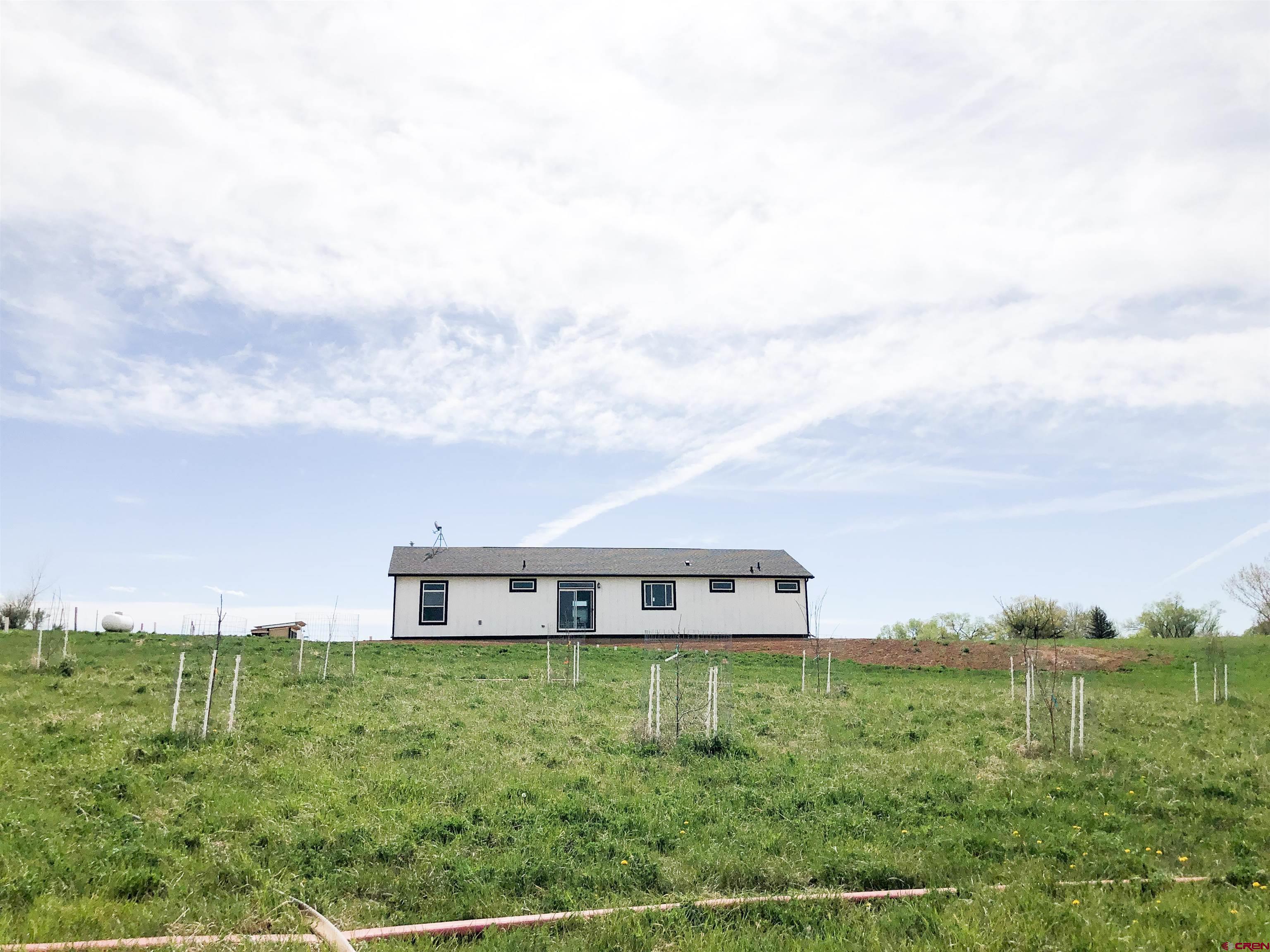 22667 Rd L Cortez, CO 81321 - Photo 30 of 35 a view of a big house with a big yard and large trees