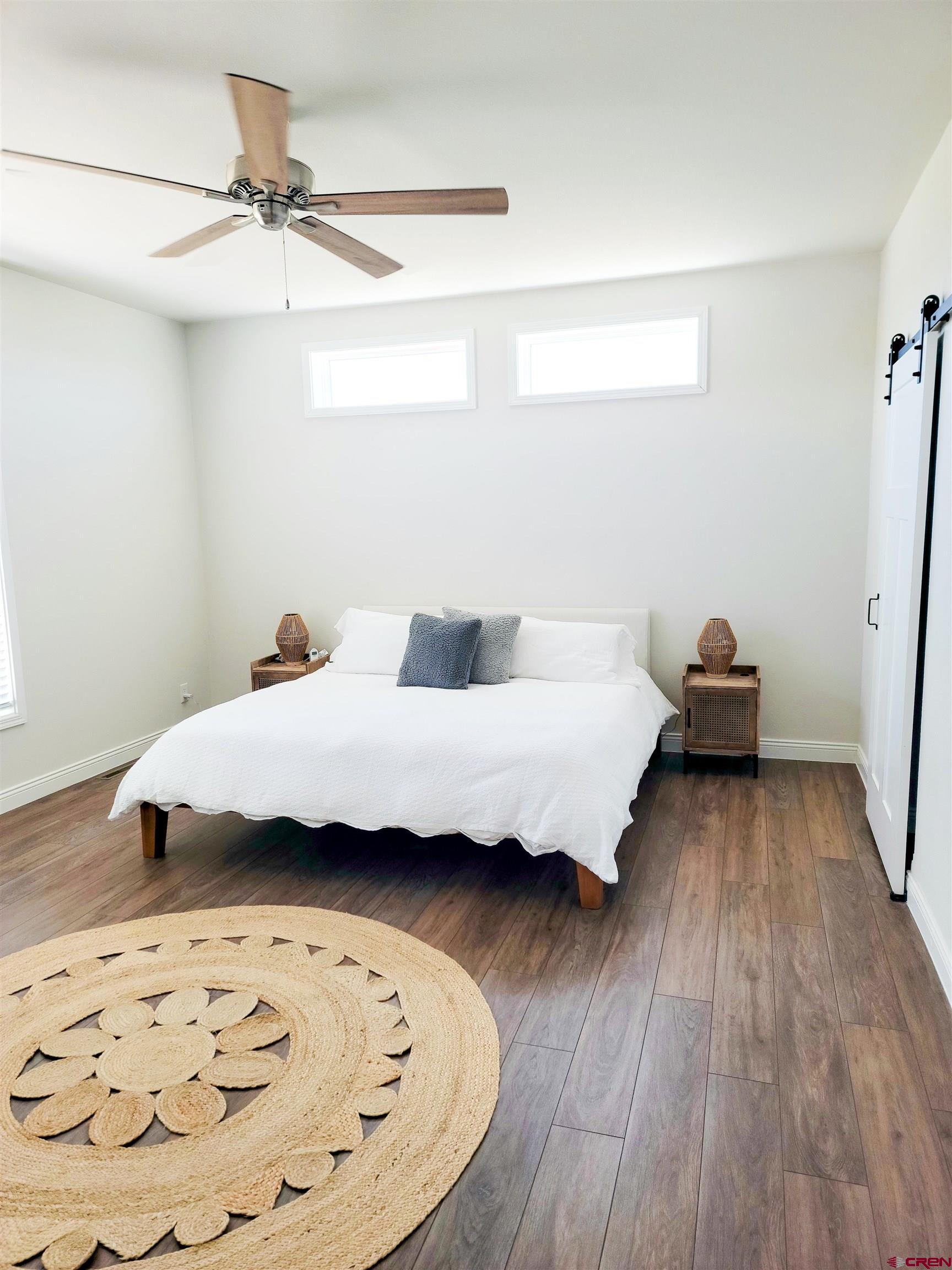 22667 Rd L Cortez, CO 81321 - Photo 10 of 35 a bedroom with a bed and wooden floor