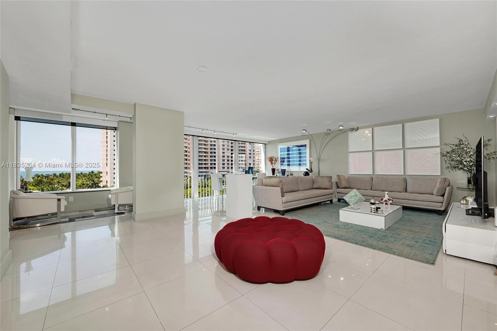 607 Ocean Drive, Unit 8K Key Biscayne, FL 33149 - Photo 3 of 8 a living room with furniture and a large window