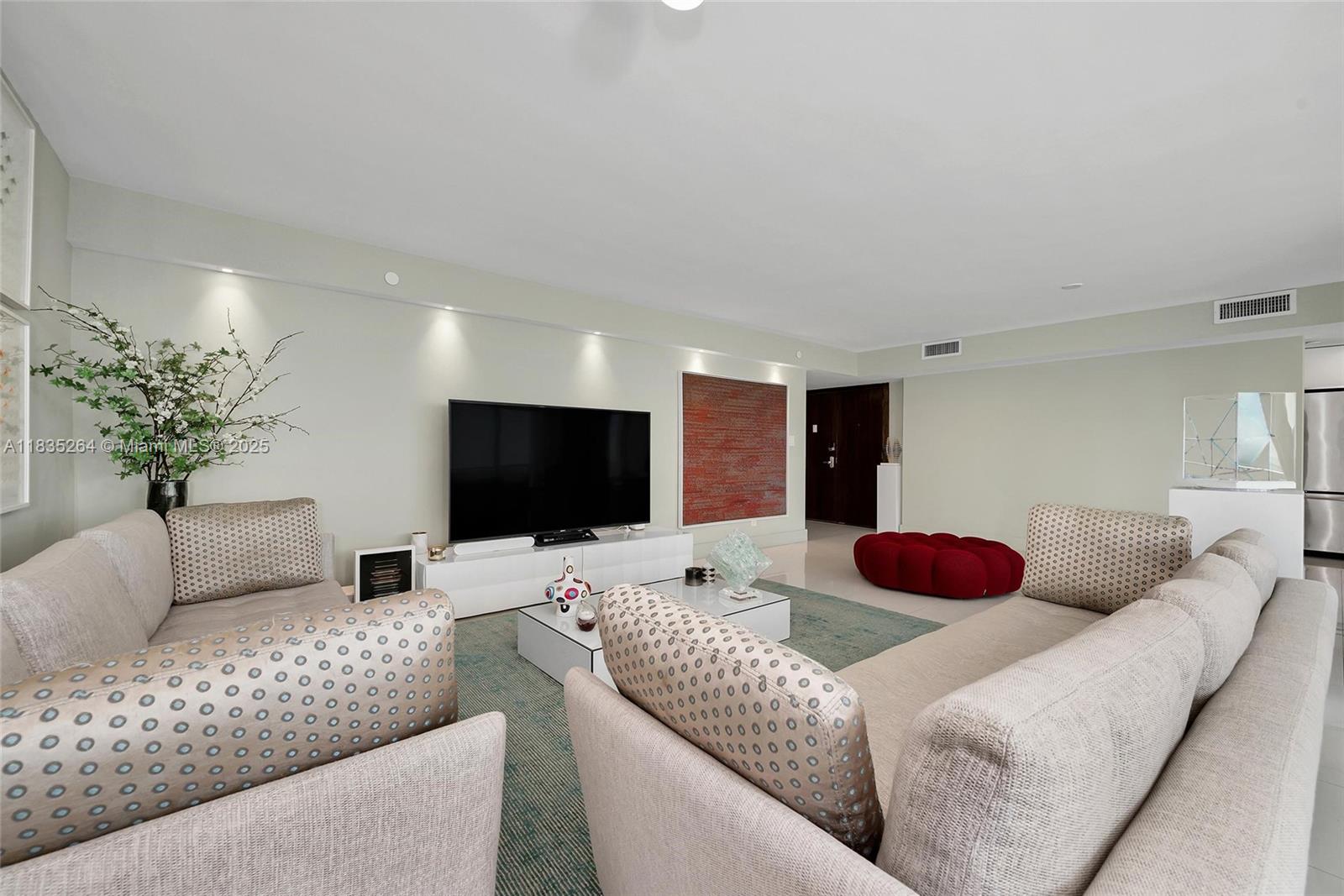 607 Ocean Drive, Unit 8K Key Biscayne, FL 33149 - Photo 6 of 8 a living room with furniture and a flat screen tv