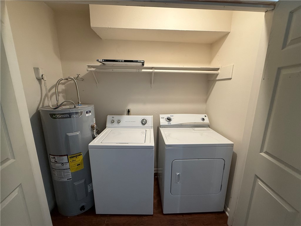 922 Spring Loop, Unit C College Station, TX 77840 - Photo 11 of 11 Washroom featuring water heater and independent washer and dryer