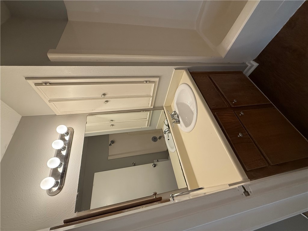 922 Spring Loop, Unit C College Station, TX 77840 - Photo 9 of 11 Full bath with vanity, tub / shower combination, and dark wood finished floors