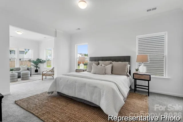 a bedroom with a bed a table and chair