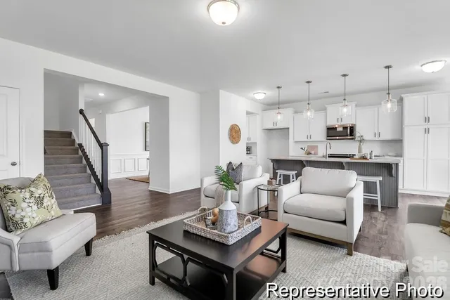 a living room with furniture and kitchen view