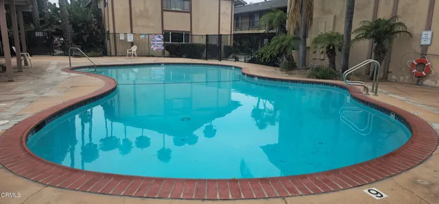 a view of a swimming pool with a patio