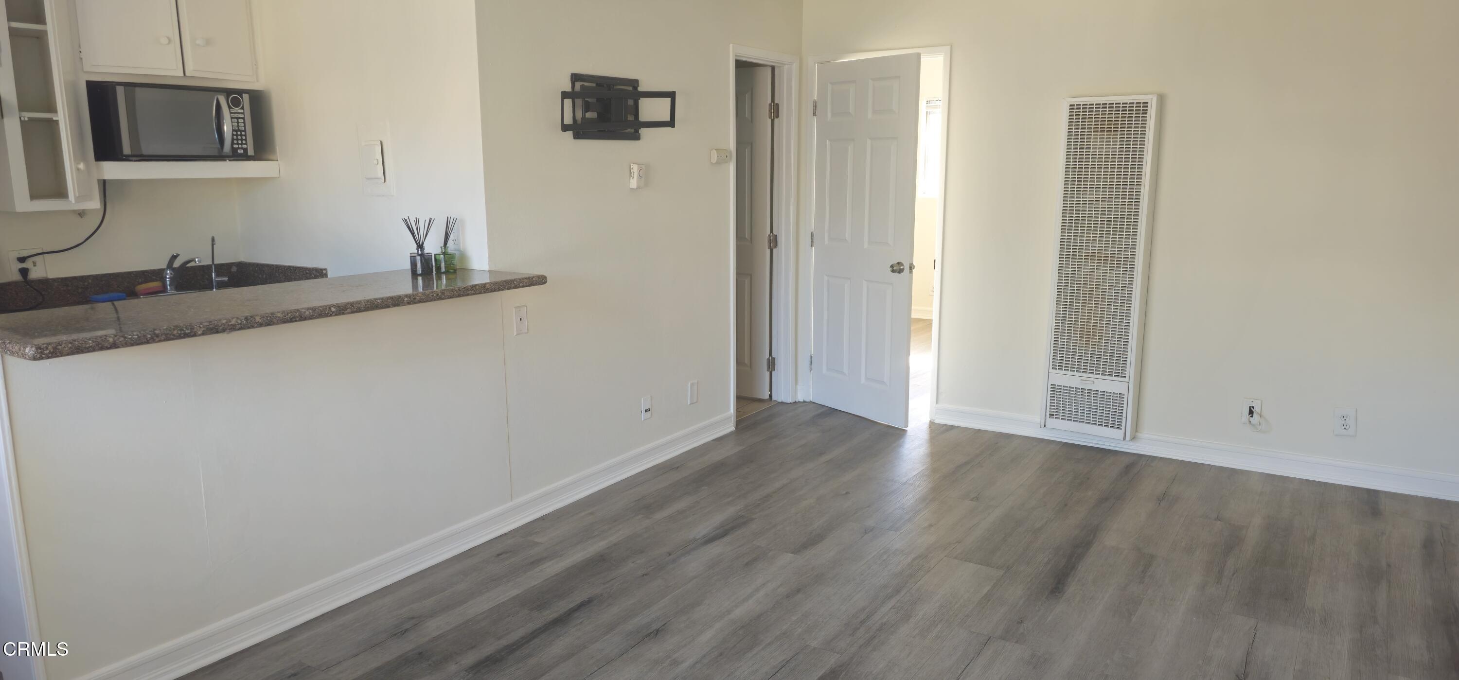 1925 Ginger Street, Unit 202 Oxnard, CA 93036 - Photo 3 of 6 a view of hallway with wooden floor and cabinet