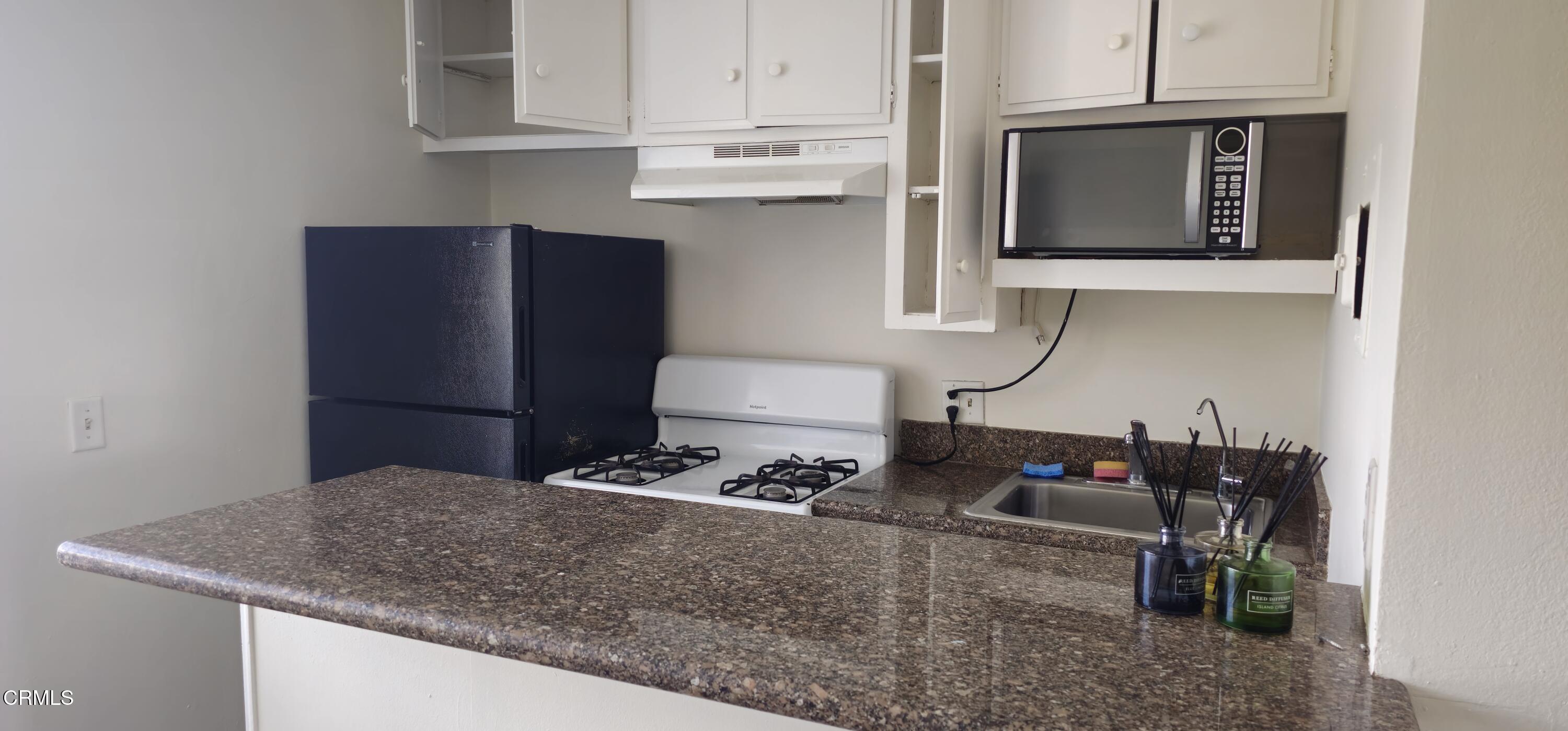 1925 Ginger Street, Unit 202 Oxnard, CA 93036 - Photo 4 of 6 a kitchen with cabinets and a sink