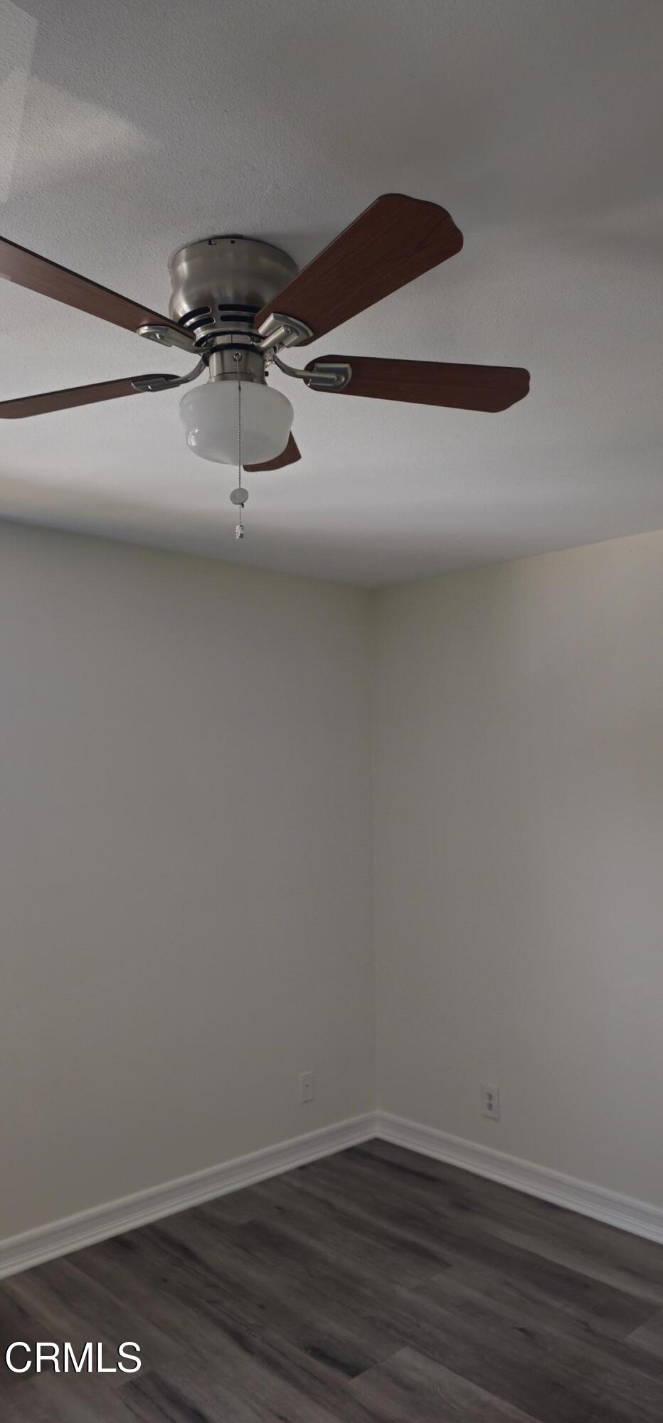 1925 Ginger Street, Unit 202 Oxnard, CA 93036 - Photo 6 of 6 a view of a room with wooden floor and ceiling fan