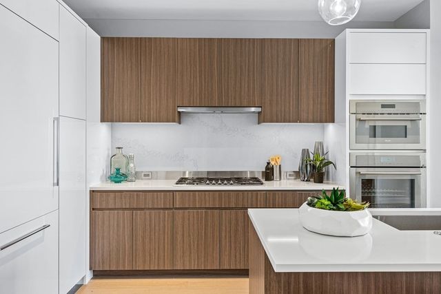 a kitchen with a cabinets and chandelier