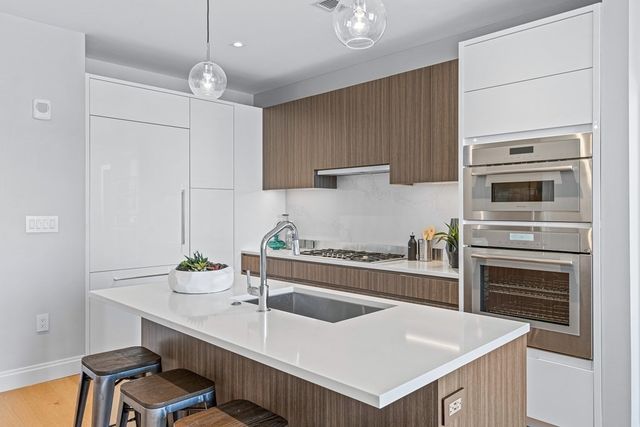 a kitchen with a stove a sink and a refrigerator