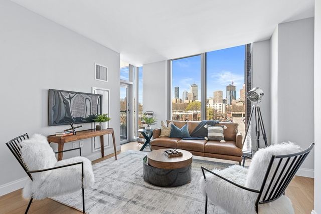 a living room with furniture and a floor to ceiling window