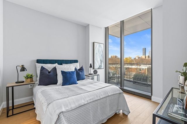a bedroom with a large bed and a large window