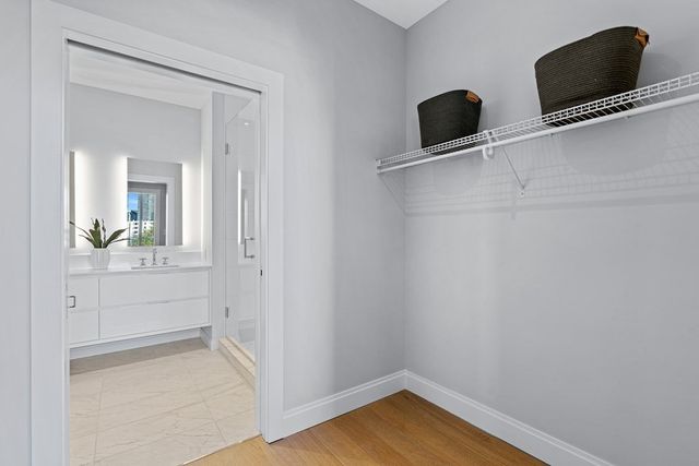 a view of a livingroom with wooden floor and cabinet