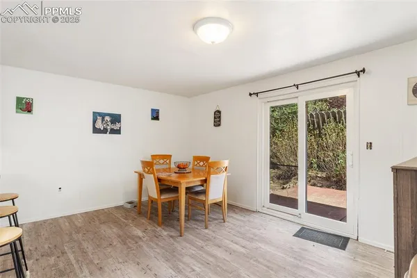 a dining room with furniture and wooden floor