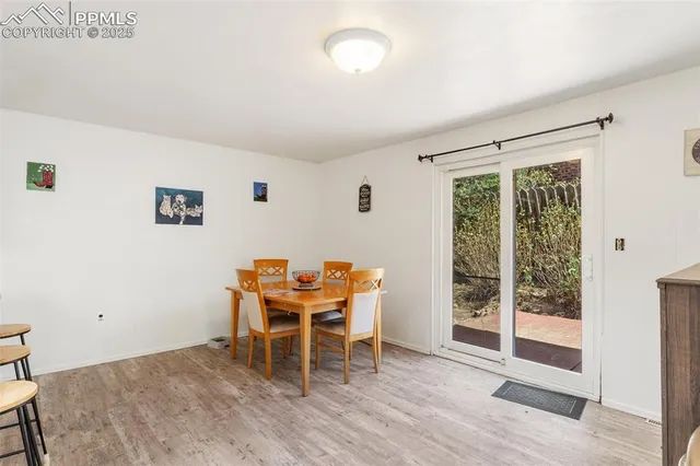 a dining room with furniture and wooden floor