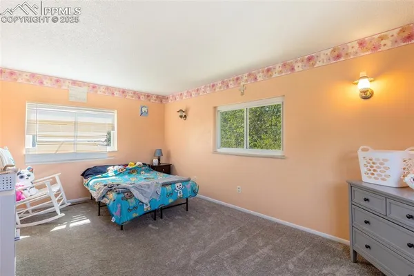 a bedroom with bed and a window