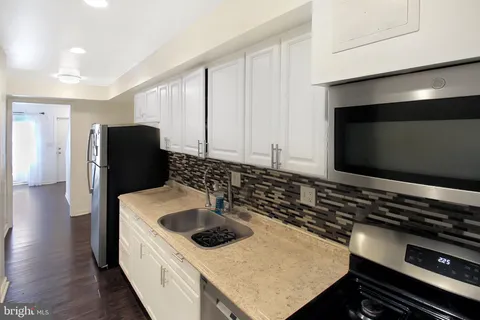 a kitchen with a stove and a refrigerator