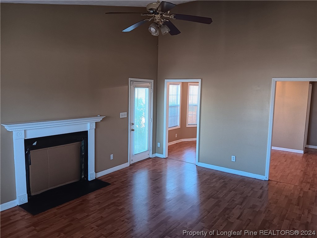 517 Woodwind Drive Spring Lake, NC 28390 - Photo 11 of 32 a view of an empty room with wooden floor and a fireplace