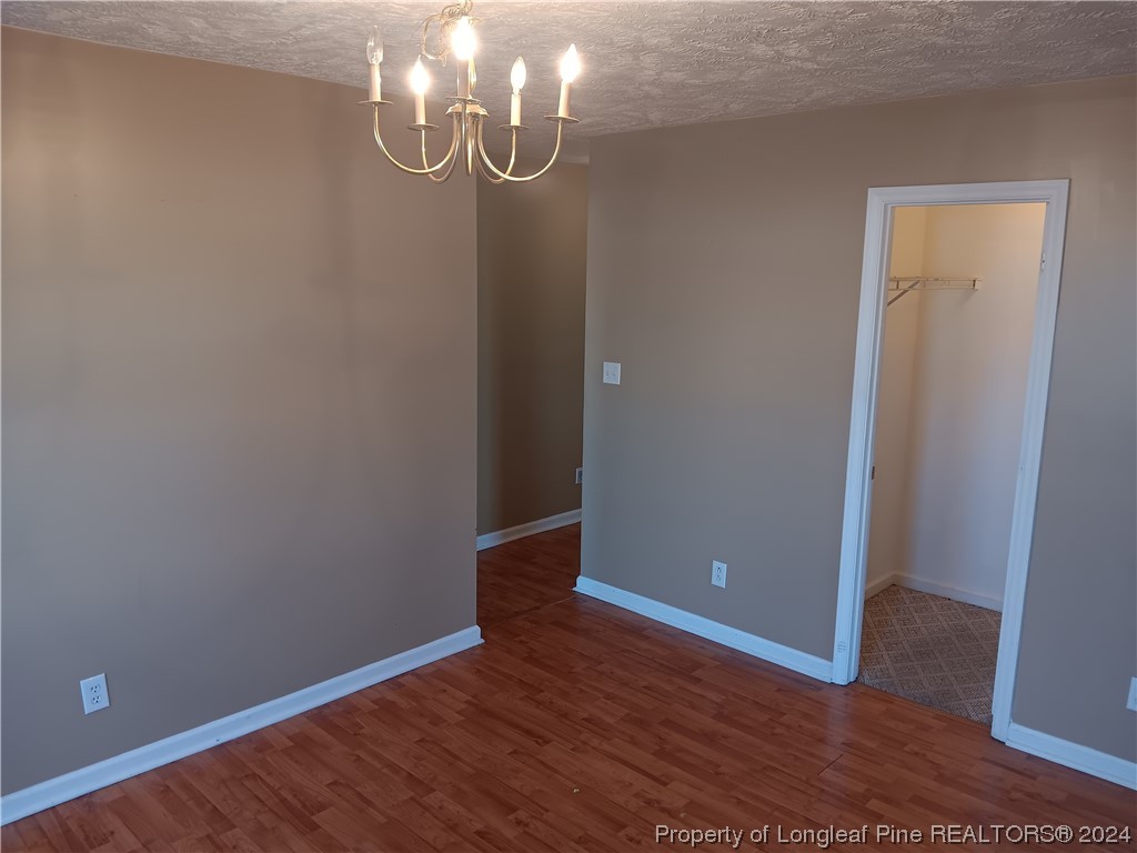 517 Woodwind Drive Spring Lake, NC 28390 - Photo 14 of 32 a view of an empty room with wooden floor