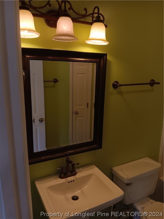 517 Woodwind Drive Spring Lake, NC 28390 - Photo 16 of 32 a bathroom with a sink and mirror