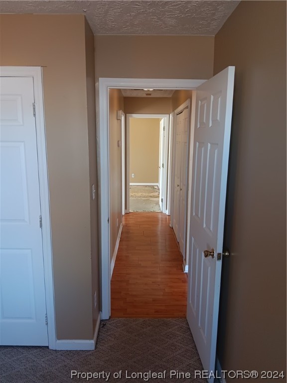 517 Woodwind Drive Spring Lake, NC 28390 - Photo 18 of 32 a view of a hallway with wooden floor and closet