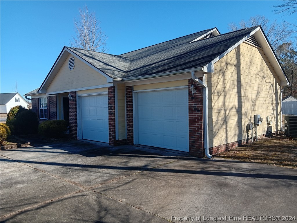 517 Woodwind Drive Spring Lake, NC 28390 - Photo 2 of 32 a view of house with wooden fence