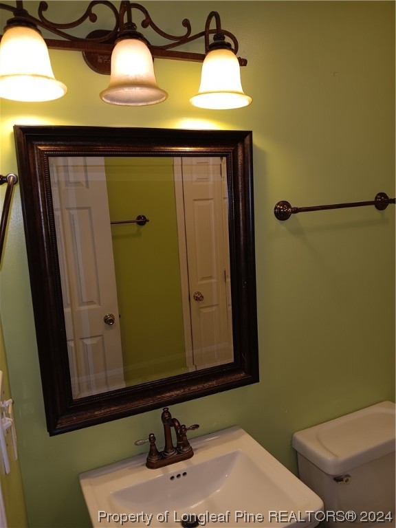517 Woodwind Drive Spring Lake, NC 28390 - Photo 28 of 32 a bathroom with a sink and a mirror