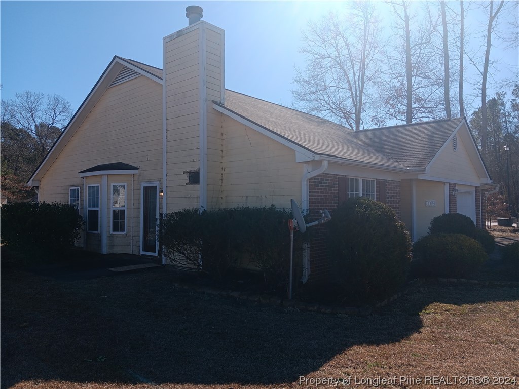 517 Woodwind Drive Spring Lake, NC 28390 - Photo 8 of 32 a roof deck with table and chairs