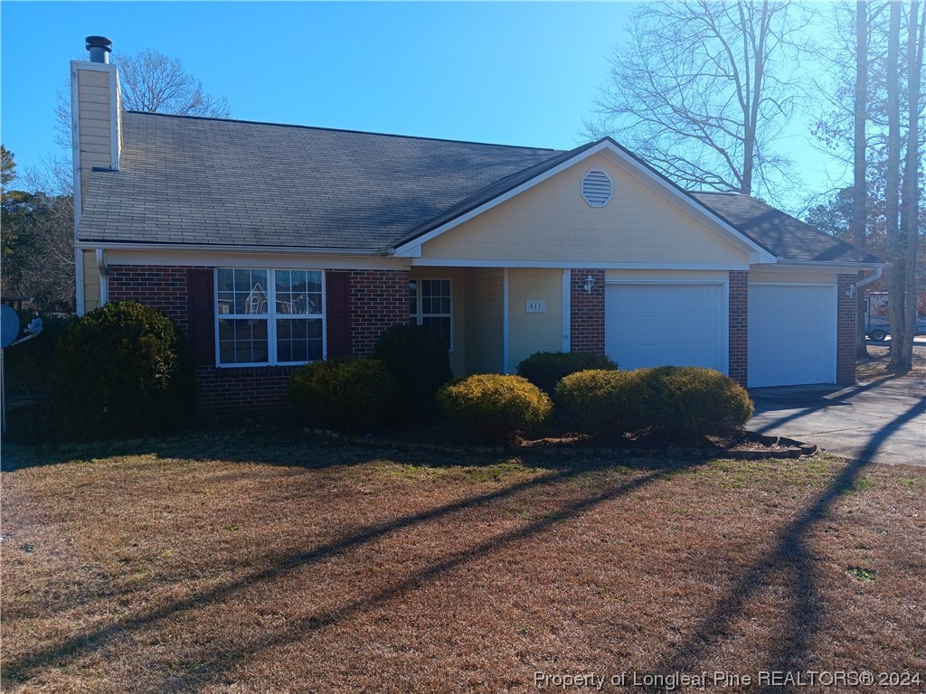 517 Woodwind Drive Spring Lake, NC 28390 - Photo 9 of 32 a view of a house with a yard