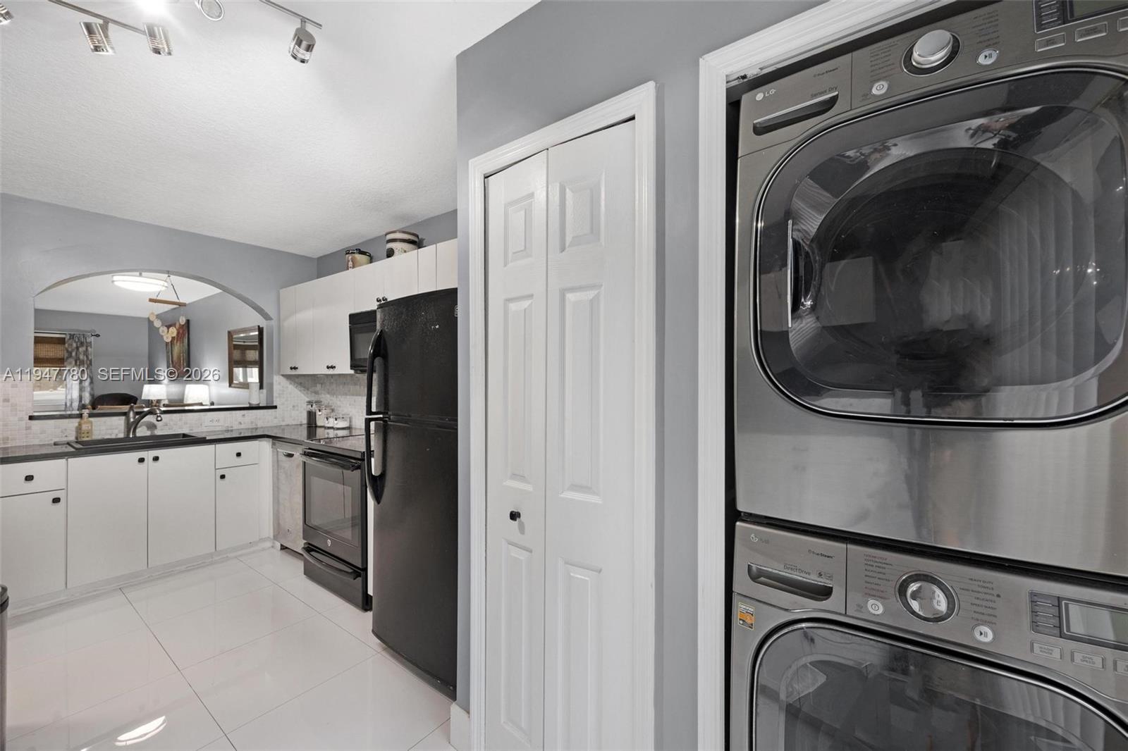985 Northeast 33rd Terrace, Unit 102 Homestead, FL 33033 - Photo 11 of 20 a kitchen with a refrigerator and cabinets