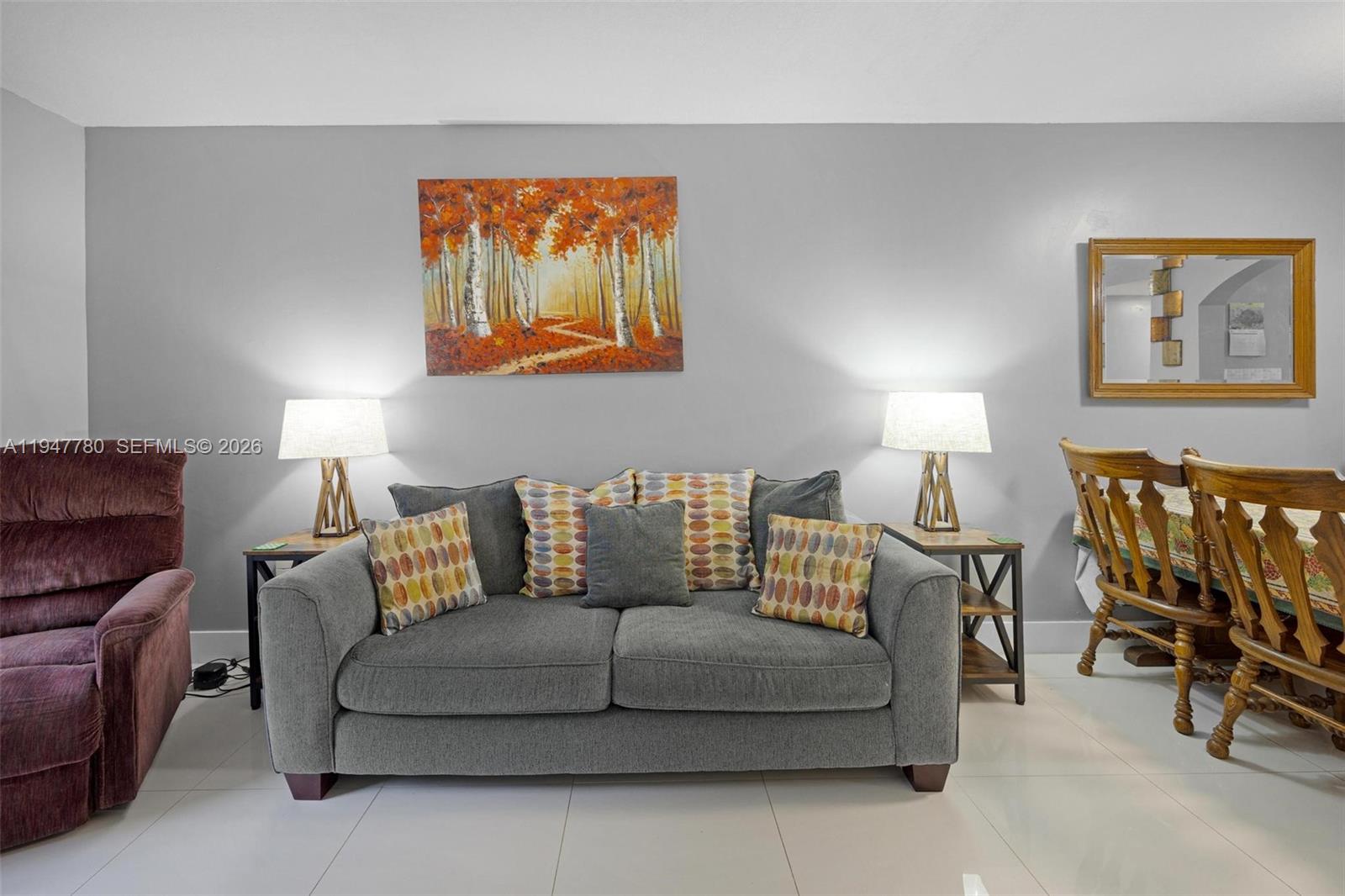 985 Northeast 33rd Terrace, Unit 102 Homestead, FL 33033 - Photo 5 of 20 a living room with furniture a lamp and a lamp