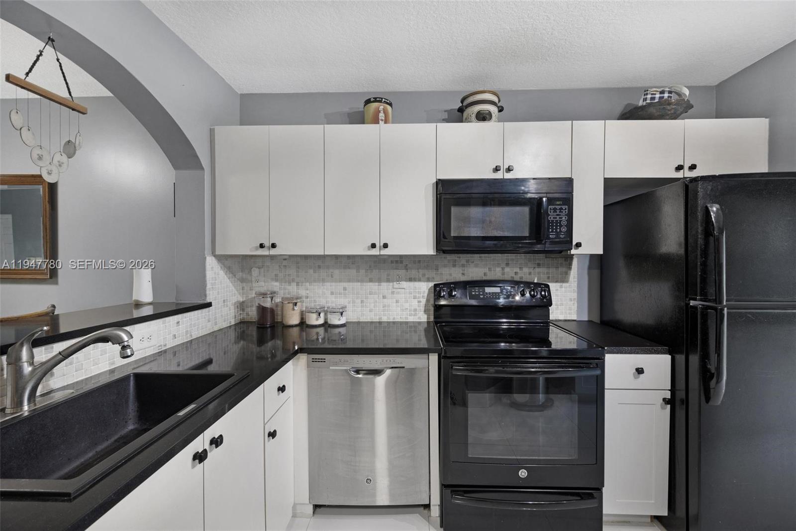 985 Northeast 33rd Terrace, Unit 102 Homestead, FL 33033 - Photo 8 of 20 a kitchen with a sink and stainless steel appliances