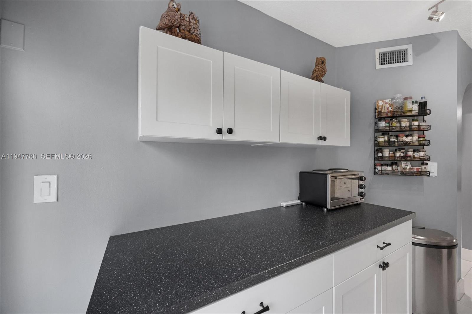 985 Northeast 33rd Terrace, Unit 102 Homestead, FL 33033 - Photo 10 of 20 a kitchen with a sink and cabinets