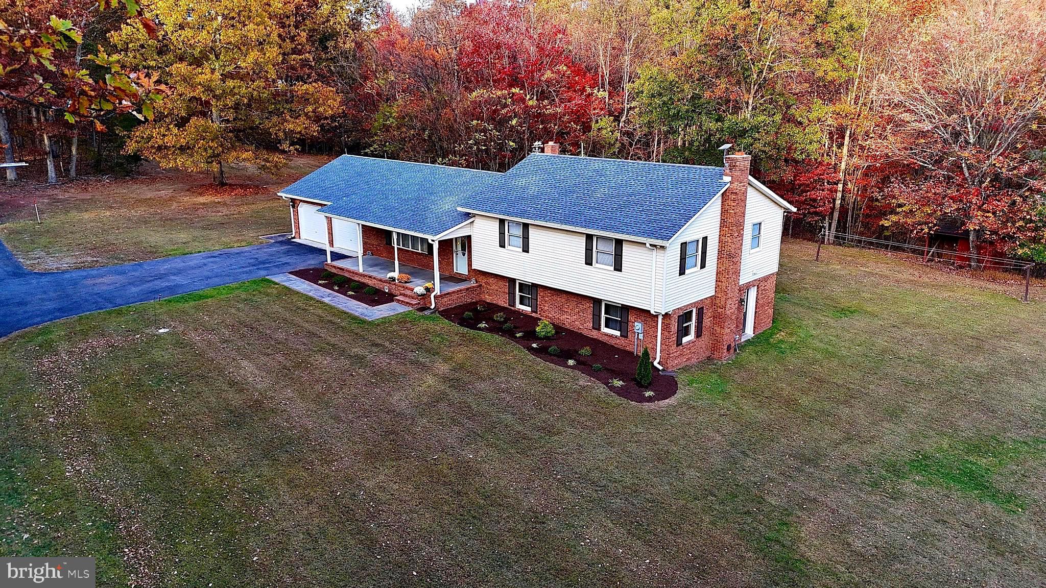 a aerial view of a house with a yard and deck