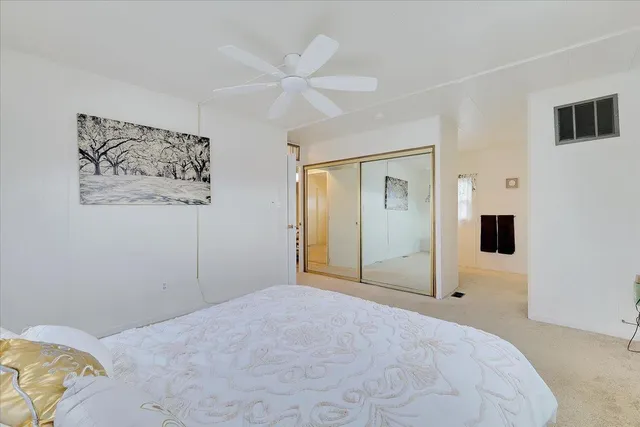 a view of a bedroom with a large bed and closet