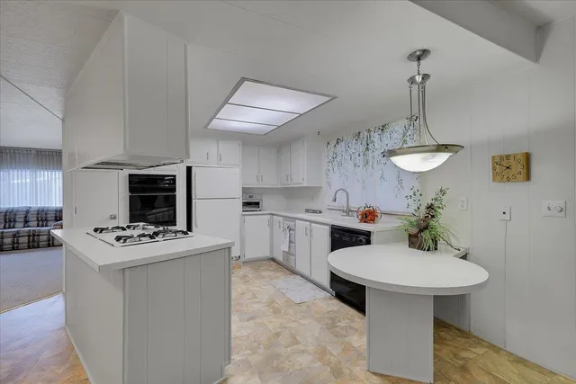a kitchen with a sink stainless steel appliances and cabinets