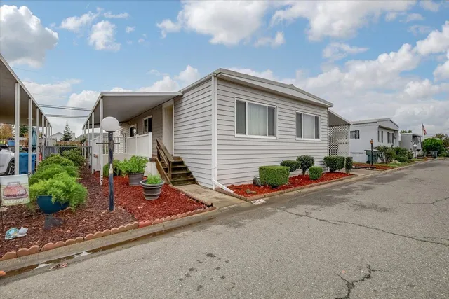 a front view of a house with garden