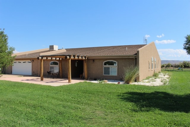 853 R Road Mack, CO 81525 - Photo 12 of 42 a front view of a house with a yard and garage
