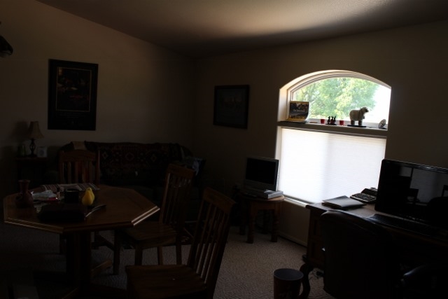 853 R Road Mack, CO 81525 - Photo 20 of 42 a living room with table chairs and a stove