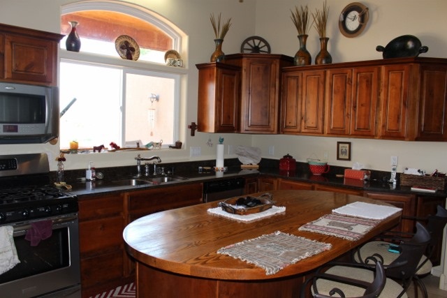 853 R Road Mack, CO 81525 - Photo 27 of 42 a kitchen with a table chairs and a stove