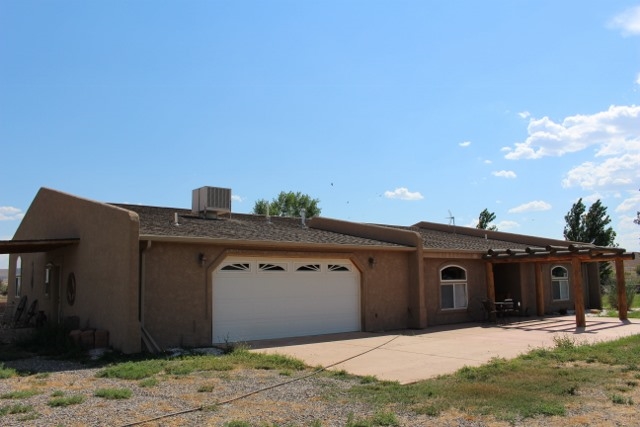 853 R Road Mack, CO 81525 - Photo 8 of 42 a front view of a house with trees