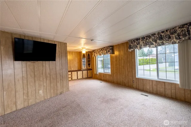 a view of an empty room with a flat screen tv