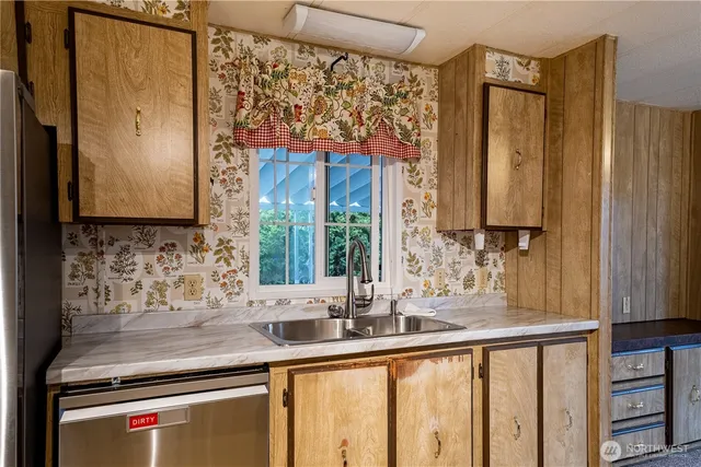 a kitchen with stainless steel appliances a sink and a window